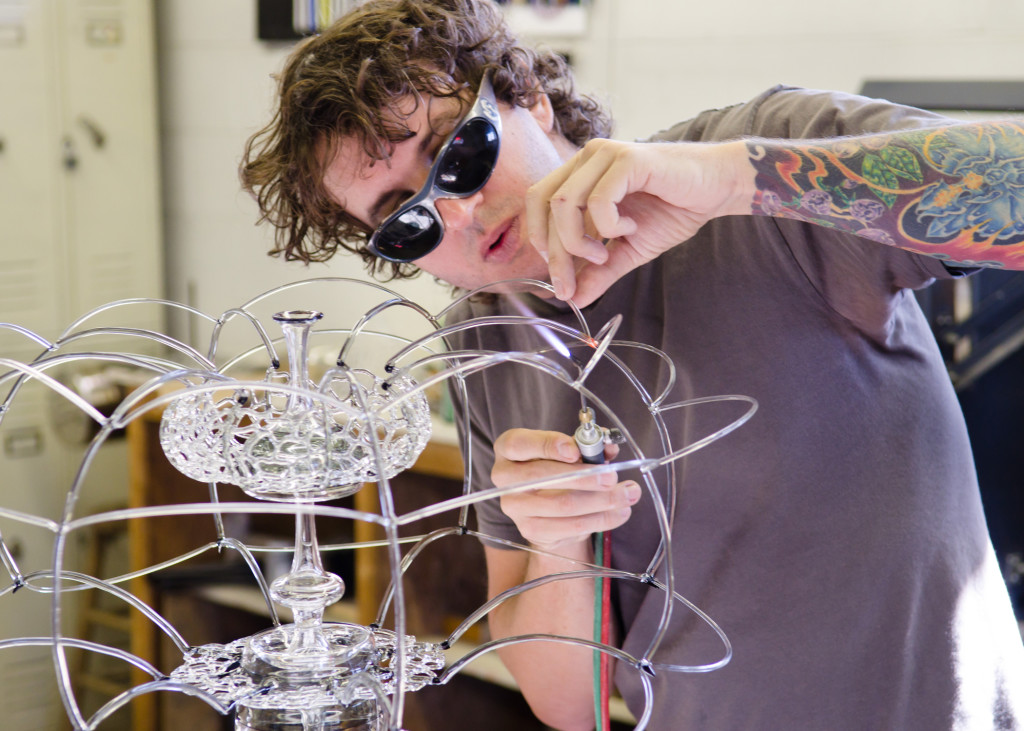Micah Evans working on a flameworked glass piece
