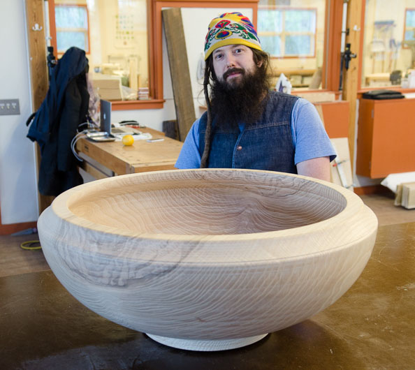 man and a large wooden bowl