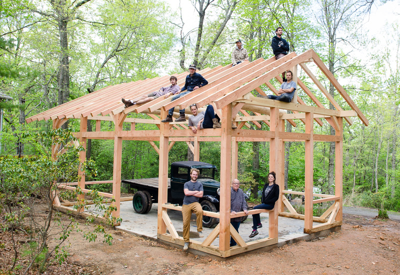 The timber framing class posing on the frame they raised