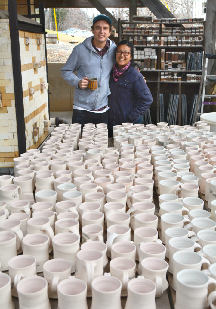 Potters pose with over 200 mugs ready to be fired