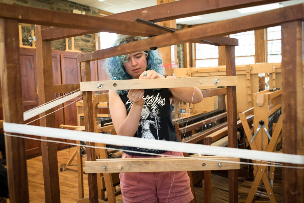 Allie Dudley using a warping mill at Penland