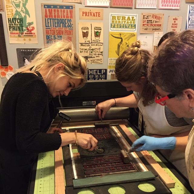 Three women working at a printing press