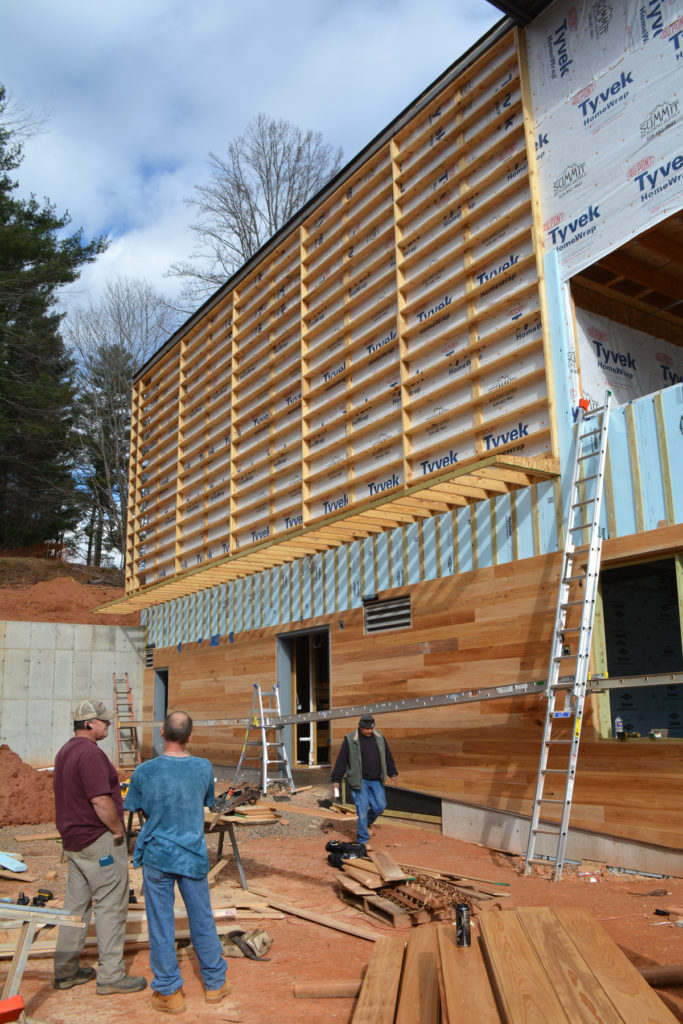 This beautiful wooden siding will clad part of the building's exterior.