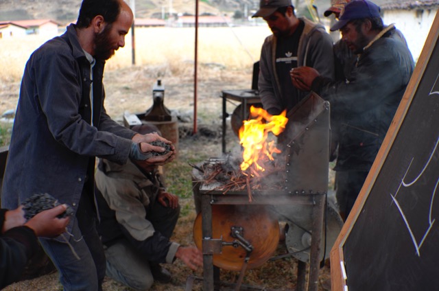 adding coal to a burning forge