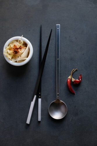 Erica Moody, Sujeo Set, chopsticks: aluminum, ebony; tasting spoon: burnished, blackened stainless steel; both pinned with brass, 9 inches long