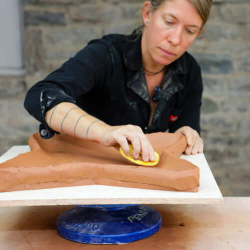 Courtney demonstrating a handbuilt tray form in the Penland clay studio